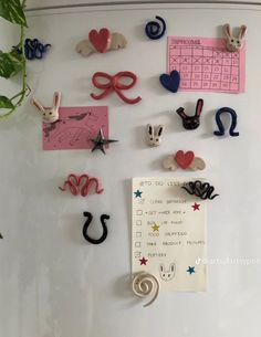 the magnets on the refrigerator are decorated with animals and hearts for valentine's day