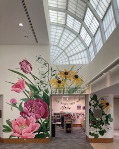 the inside of a building with flowers painted on the wall and windows in the ceiling