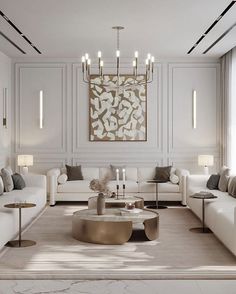 a living room filled with white couches and tables in front of a painting on the wall