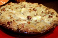 a pie sitting on top of a red plate