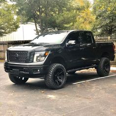 a black truck parked in a parking lot