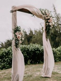 a wedding arch with flowers and greenery