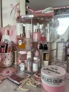 the vanity is full of cosmetics and beauty products, including eye creams, lip glosses, eyeshades