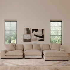 a living room with three windows and a couch