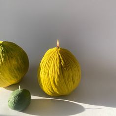 there are two lemons next to each other with a candle on the top one