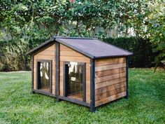 a small wooden dog house in the grass