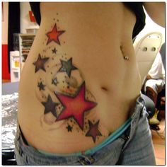 a woman's stomach with stars painted on the side and in between her belly