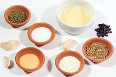 the bowls are filled with different types of spices