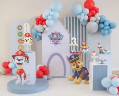 a birthday party with balloons and decorations for a puppy themed baby's first birthday