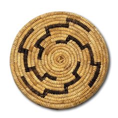 a round basket with black and brown designs on it