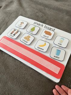 a person is playing with a snack board game on the bed in front of them