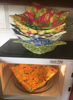 there are three bowls on top of each other in the microwave, and one is filled with flowers