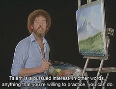 a man standing in front of an easel with a painting on it's side