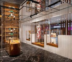 the inside of a store with many items in glass cases and wooden shelves on the wall