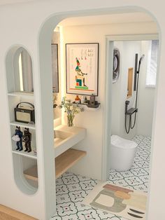 the bathroom is decorated in white and has an arch shaped doorway that leads into another room