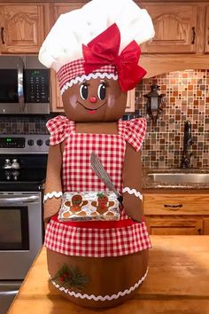 a large inflatable gingerbread man standing on top of a kitchen counter