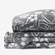 three sheets with footballs on them are stacked up in front of eachother