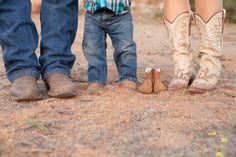 three people standing next to each other wearing cowboy boots