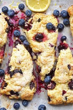 blueberries and lemon scones on a baking sheet