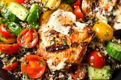 grilled chicken with tomatoes, cucumbers, and couscous on top of rice