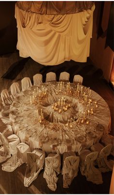 a round table with many candles on it