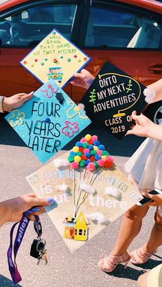 people holding up signs and balloons in front of a car