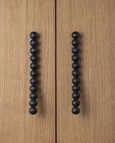 two wooden doors with black knobs on them