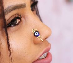 Strengthen your inner goddess and style, with this evil eye protection nose cuff.Adjustable (one size fits all), this gold nose cuff is super trendy and comfortable :- adjusts to your unique nose shape with a simple gentle pinch. Perfect to treat yourself & for gift giving!🧿 Details 🧿 :* Material: handcrafted from  tarnish-resistant highest  quality gold plated wire;*  Dainty glass Evil Eye Charm; ► Please NOTE: Due to health/hygiene reasons, our nose cuffs can not be returned.► Comes beau Evil Eye Nose Ring, Unique Handmade Nose Rings As Gift, Gold Nose Cuff, Nose Ring Fake, Wire Jig, Cute Nose Piercings, Sterling Silver Nose Rings, Fake Nose Ring