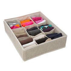 an open drawer with several pairs of socks and scarves in it on a white background