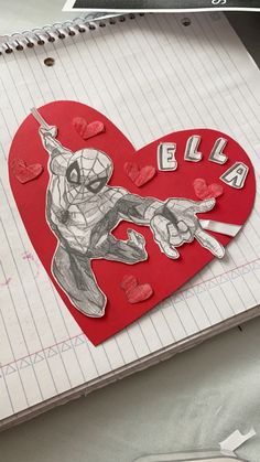 a paper cut out of a spiderman holding a knife in front of a heart