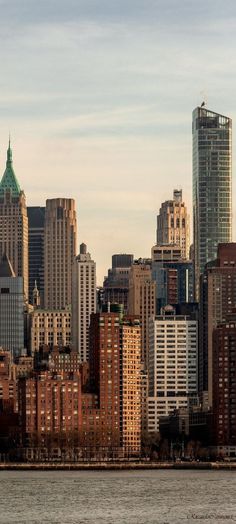 the city skyline is seen from across the water