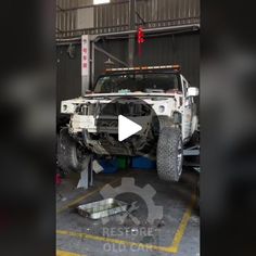 the front end of a white truck in a garage