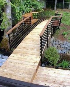 a wooden bridge crossing over a small creek