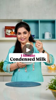 a woman standing in front of a counter holding a plate with the words i minute condenseed milk on it