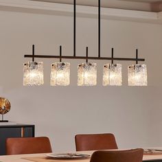 a chandelier hanging over a dining room table