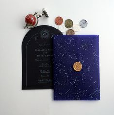 a card and some coins are laying on the table with it's cover open