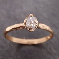 a gold ring with a white diamond in it