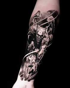 a man's arm is covered in black and white ink with an image of a demon