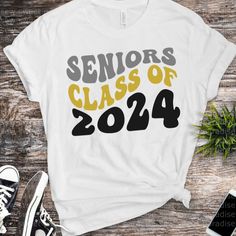 a white shirt with the words seniors class of 202 printed on it next to a pair of sneakers