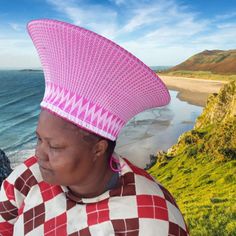 Plain pink and white ZULU HAT is called ISICHOLO in traditional Zulu language and is traditionally worn during religious and cultural ceremonies. by the married Zulu woman of South Africa   The form of the isicholo, or married woman's hat, developed out of a 19th-century conical hairstyle that was worn as a sign of respect to one's husband and his family, in addition to serving as a public symbol of married status. In the early 20th century, a removable hat like this one replaced the hairstyle. Traditional White Festival Hat, White Traditional Festival Hat, Traditional White Hat For Festival, Traditional White Ceremonial Hat, Traditional White Cap, Traditional White Wide Brim Hat, Zulu Language, Zulu Hat, Basket Hat