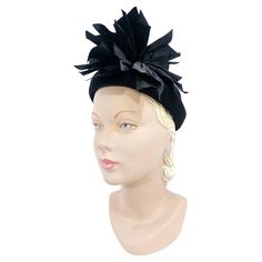 Late 1930s to early 1940s black wool felt hat with a hand rolled brim, domed crown, and an off-centered fan of gathered taffeta. The interior has a grosgrain inner hat band. The inner circumference of this hat is 20.5 inches however it is important to keep in mind that this hat is no to be worn around the head and more on the head secured with a hat pin. Luxury Vintage Wool Top Hat, 30s Feather Hat, 1940s Felt Hat, 1930’s Hats, Vintage Black Hat With Feathers, 1960s Hats, Black Wool Hat, 1940s Hats, Pink Monogram