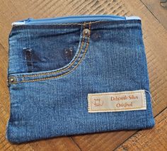 a denim pouch with a label on it