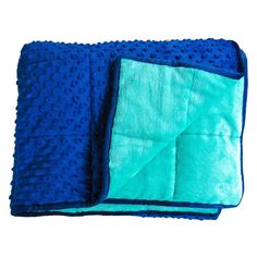 two blue and one green microfil towels on top of each other with holes in the middle