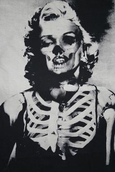 a black and white photo of a woman with skeleton makeup on it's face