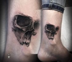 two tattoos on the legs of people with black ink and white ink, depicting skulls