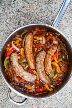 sausages, peppers and onions in a pan on a table with the title above it