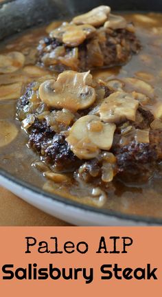 a bowl filled with meat and mushrooms on top of a table