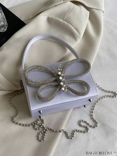 BagForLove - Chic Mini Handheld Bag with Bow-knot, Rhinestone, and Metal Chain Product Description Color White Details Rhinestone Type Square Bag Bag Size Mini Style Casual Strap Type Chain Pattern Type Plain Closure Type Magnet Composition 100% Acrylic Material Satin Size Chart INCH CM Strap Length Bag Length Bag Width Bag Height Handle Height 47.2 inch 7.1 inch 3.1 inch 4.3 inch 3.9 inch Strap Length Bag Length Bag Width Bag Height Handle Height 120 cm 18 cm 8 cm 11 cm 10 cm Details Pictures S Chic Rhinestone Shoulder Bag As Gift, Chain Pattern, Mini Handbag, Mini Bows, Mini Handbags, Bag Bag, Square Bag, Mini Fashion, Acrylic Material