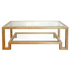 a coffee table with glass top and metal frame on the bottom, against a white background