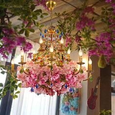 a chandelier with pink flowers hanging from it